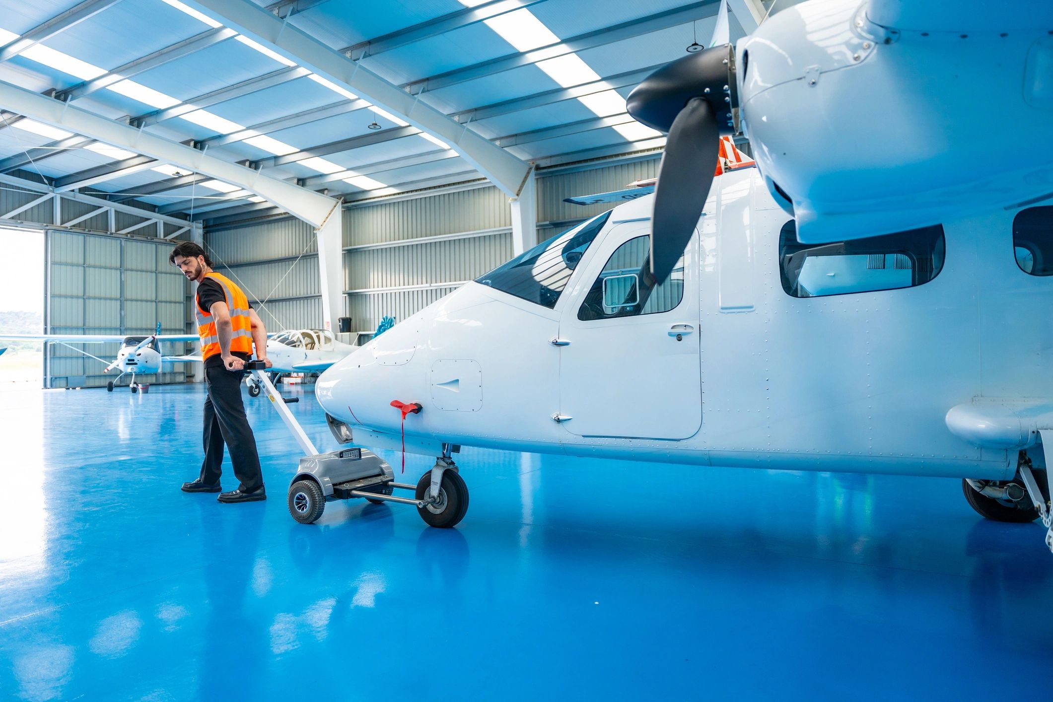 Aircraft in hangar with aviation technician